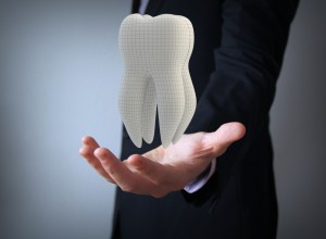 man holding tooth model
