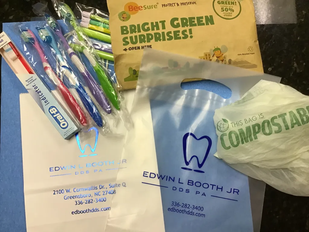 Image displaying minimally packaged toothbrushes and biodegradable bags